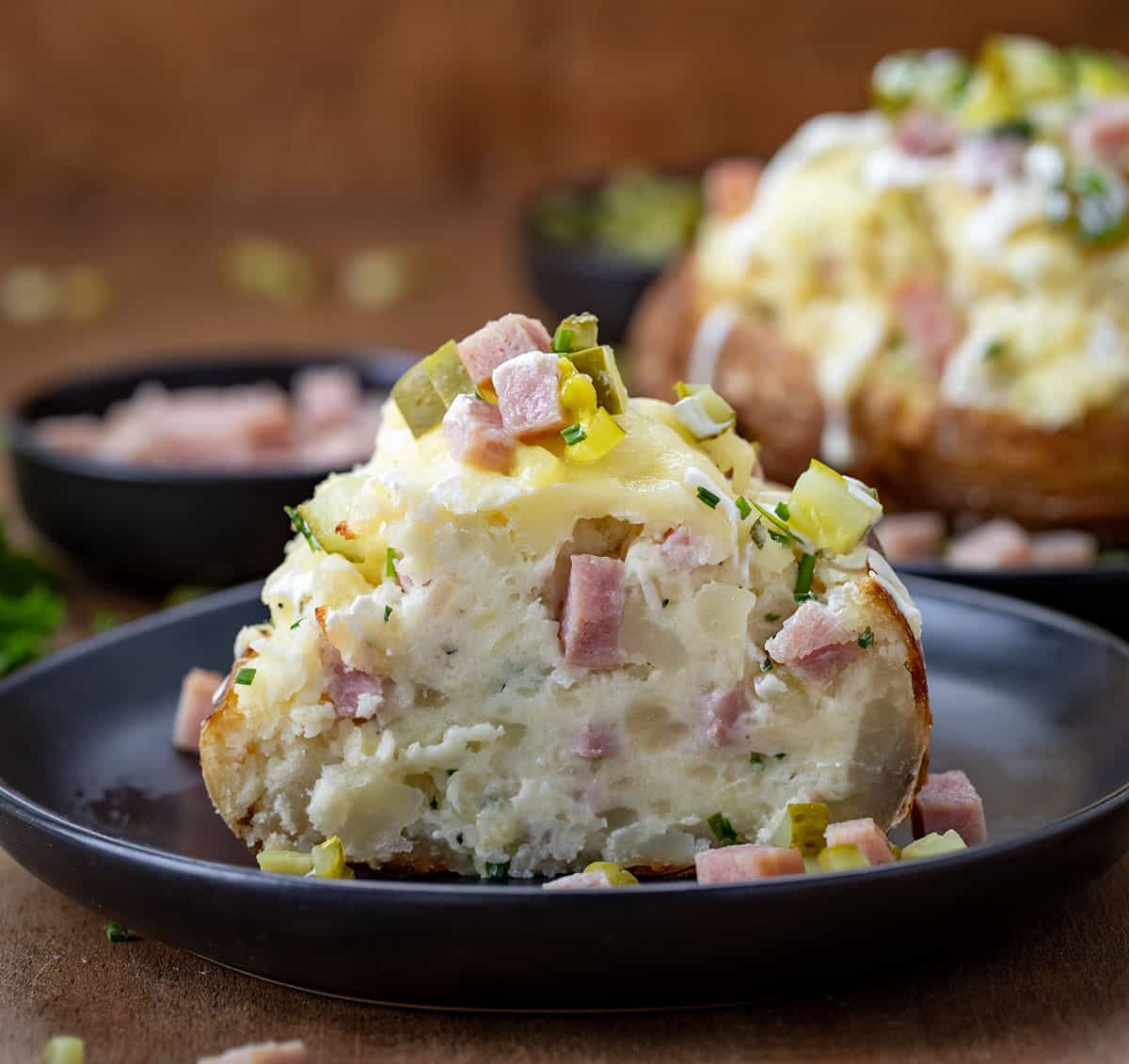 A Dill Pickle and Ham Twice Baked Potato cut in half showing the inside.