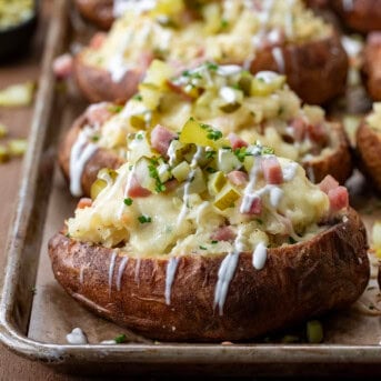 Close up of Dill Pickle and Ham Twice Baked Potatoes on a sheet pan.