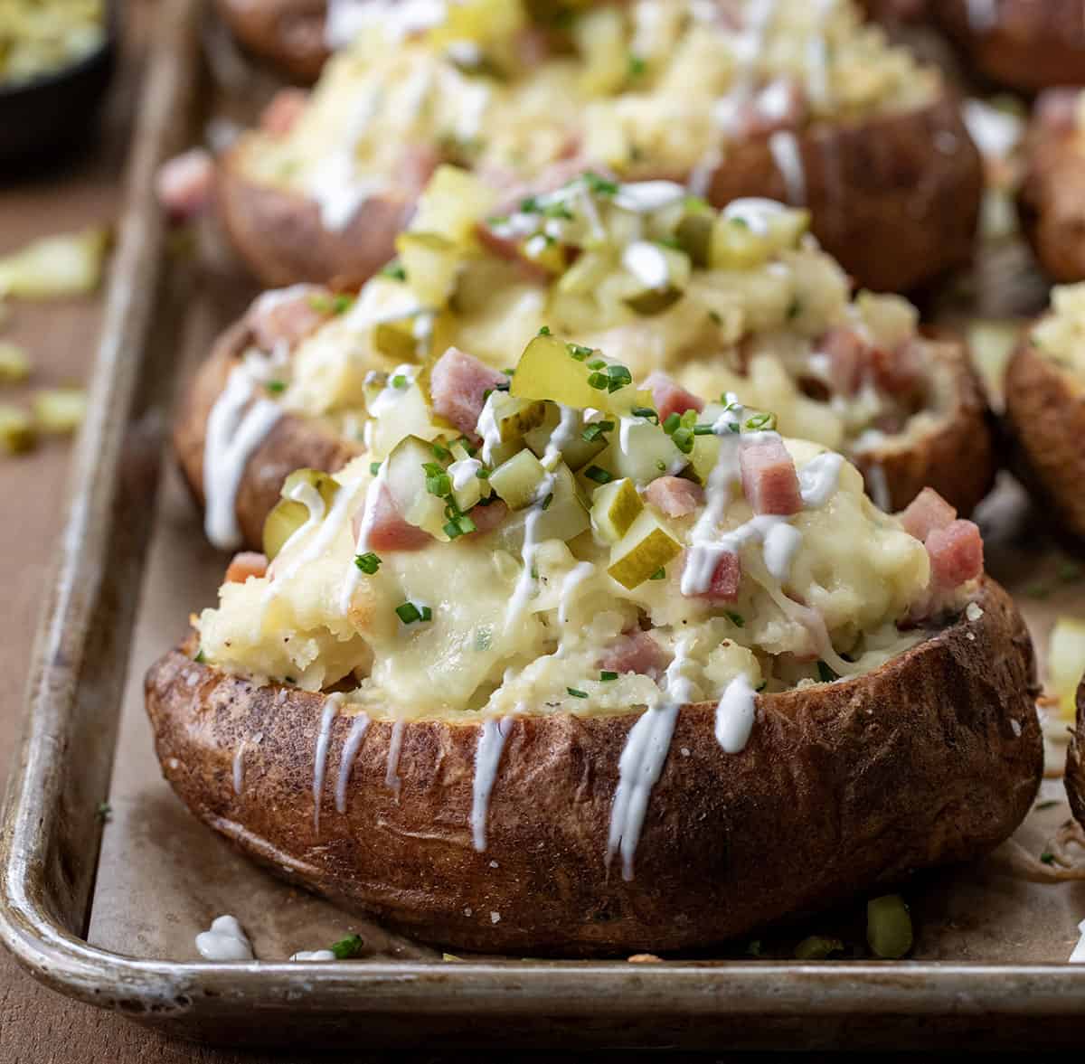 Close up of Dill Pickle and Ham Twice Baked Potatoes on a sheet pan.