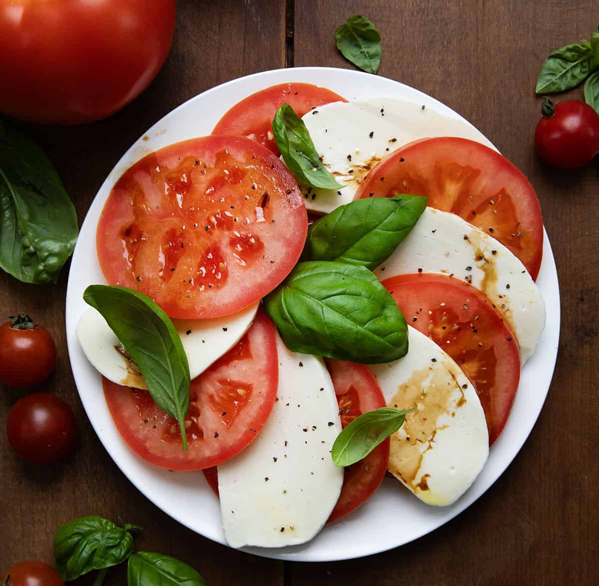 Plate of fresh Homemade Mozzarella and tomatoes and basil.