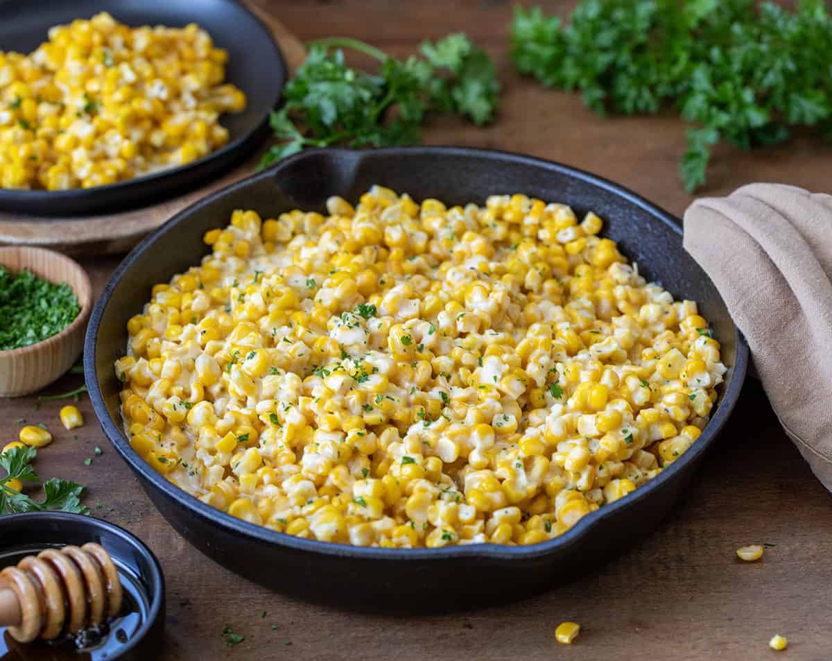 Honey Butter Skillet Corn on a wooden table.