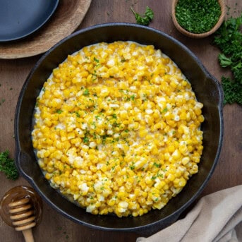 Honey Butter Skillet Corn on a wooden table from overhead.