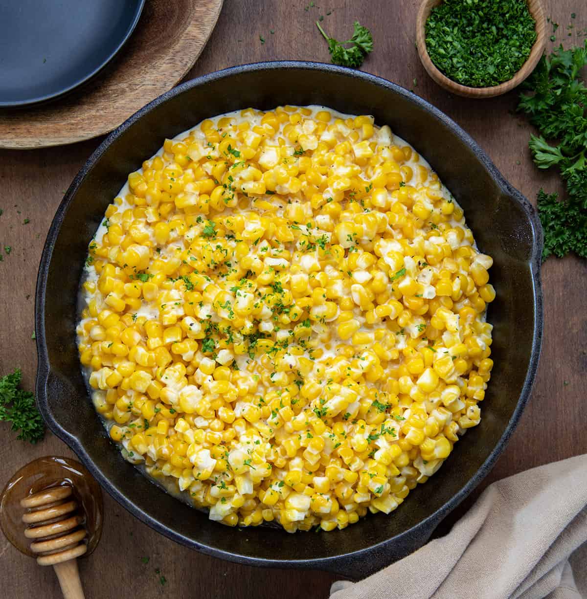 Honey Butter Skillet Corn on a wooden table from overhead.