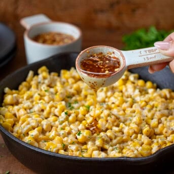 Drizzling hot honey over skillet corn.