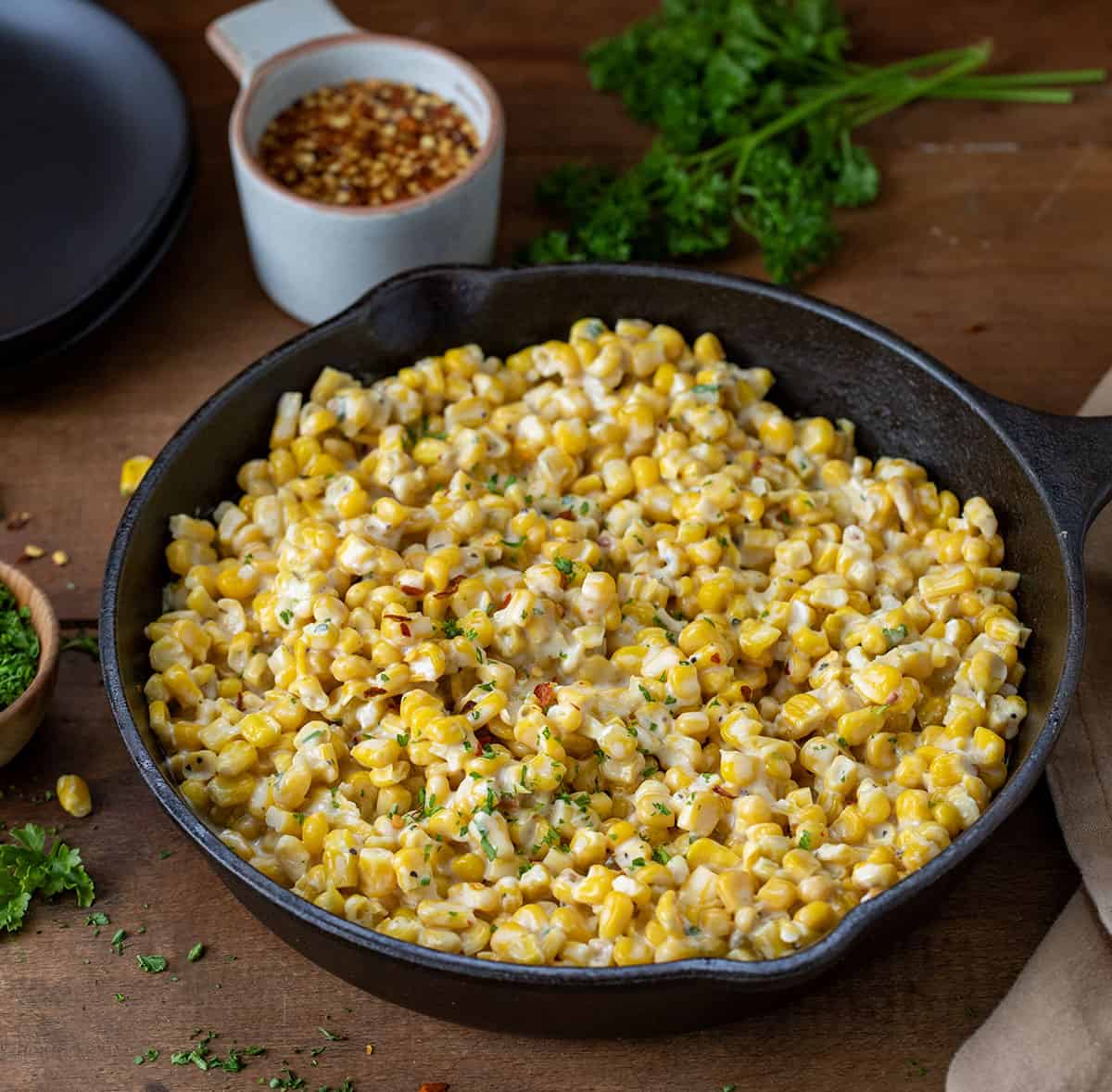 Skillet of Hot Honey Butter Corn on a wooden table.