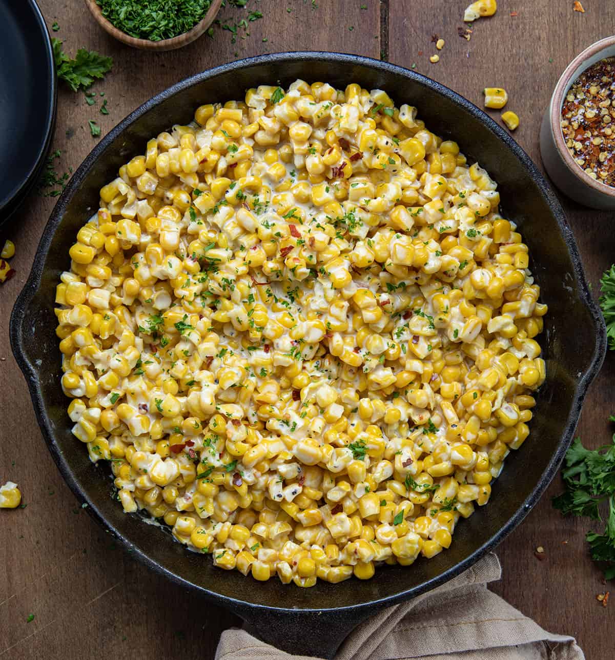 Hot Honey Skillet Corn on a wooden table from overhead.