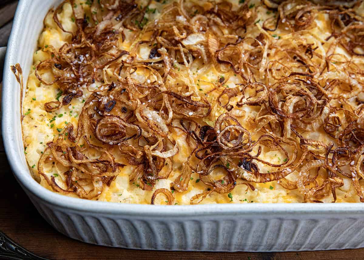 Close up of homemade fried onions on top of Funeral Potatoes in pan.