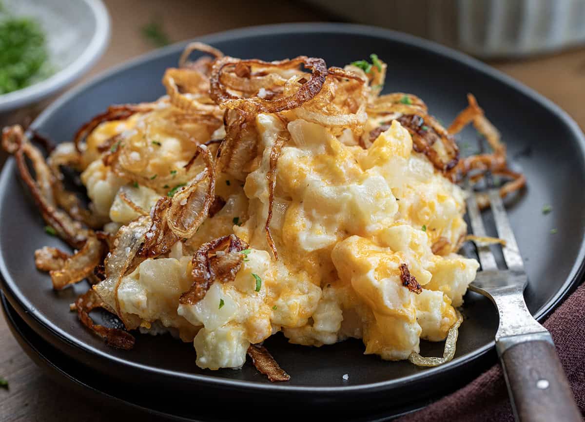 Plate of French Onion Funeral Potatoes with a fork resting on plate.