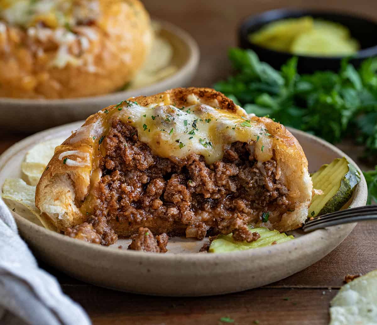 Bread Bowl Sloppy Joes cut in half showing inside filled with sloppy joe.