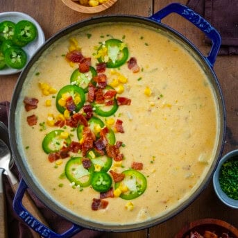 Pot filled with Jalapeno Popper Corn Chowder on a wooden table from overhead.