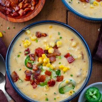 Bowls of Jalapeno Popper Corn Chowder on a wooden table from overhead.