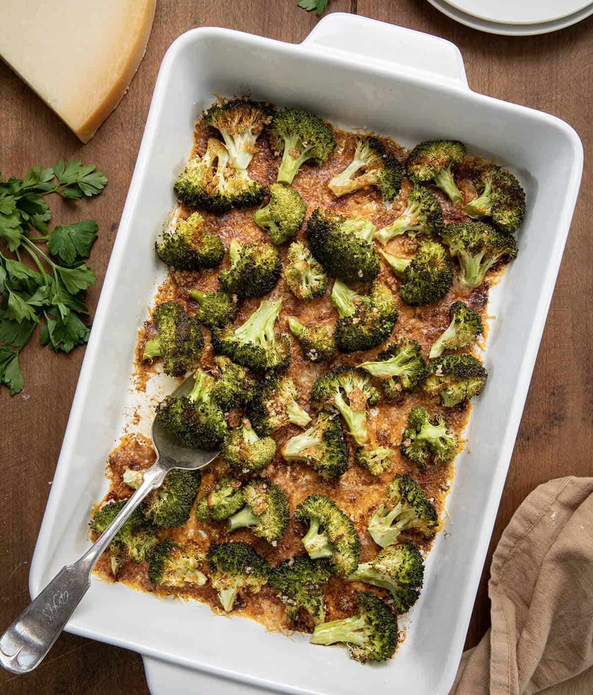 Pan of Parmesan Crusted Broccoli on a wooden table from overhead.