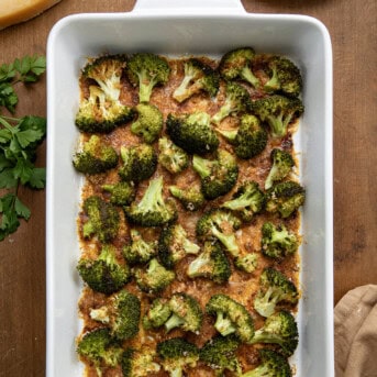 Pan of Parmesan Crusted Broccoli on a wooden table from overhead.