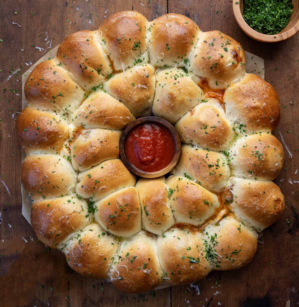 Pizza Bomb Wreath on a wooden table from overhead.