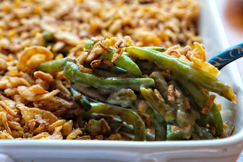 Scoop of green bean casserole out of corner of baking dish.