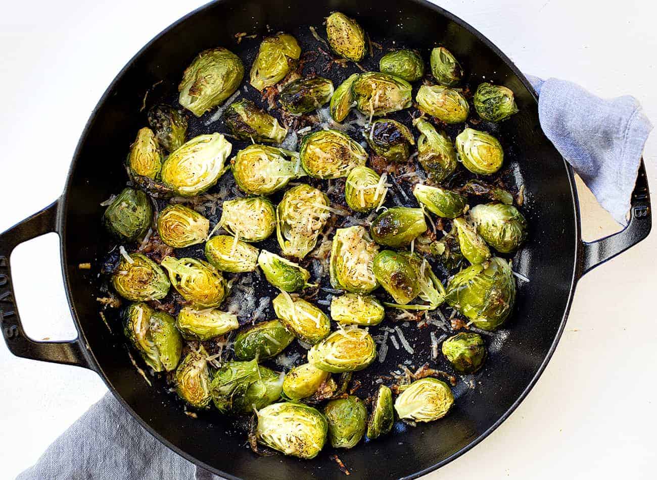 overhead of parmesan roasted Brussels sprouts in a skillet