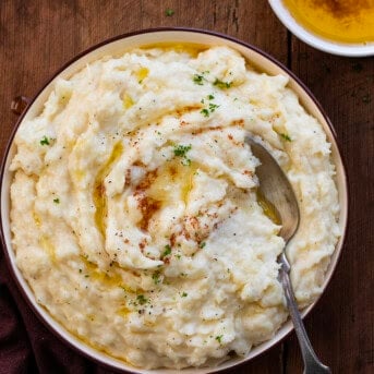 Bowl of Brown Butter Mashed Potatoes on a wooden table from overhead.