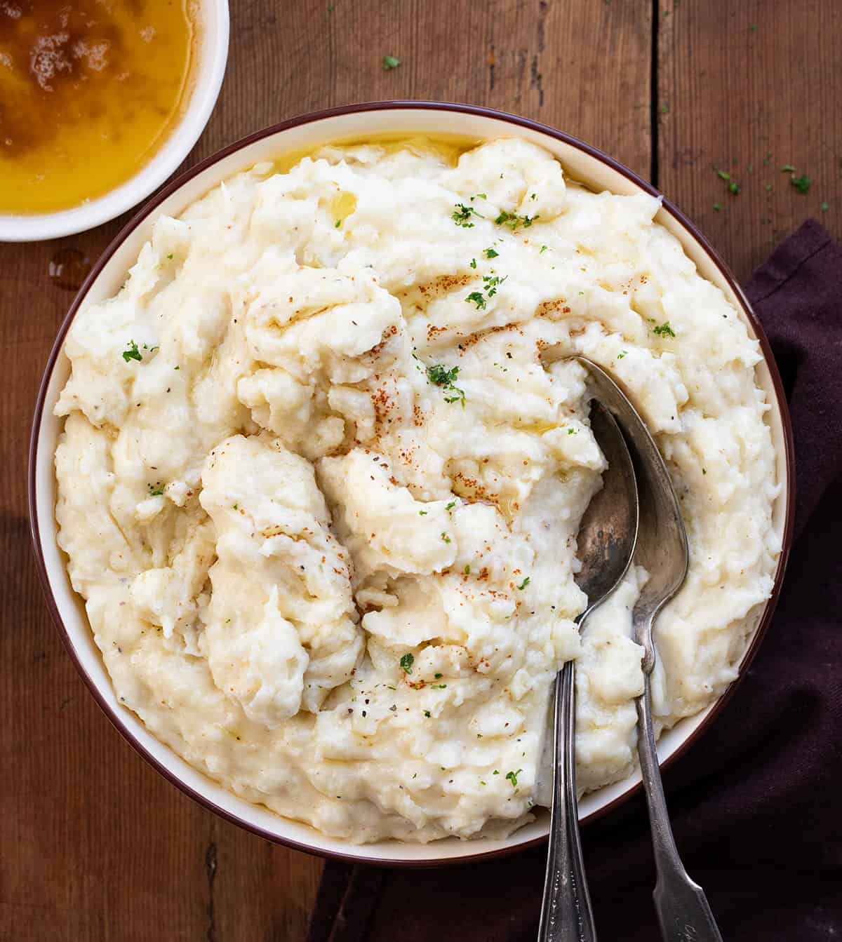 Bowl of Brown Butter Mashed Potatoes on a wooden table from overhead.