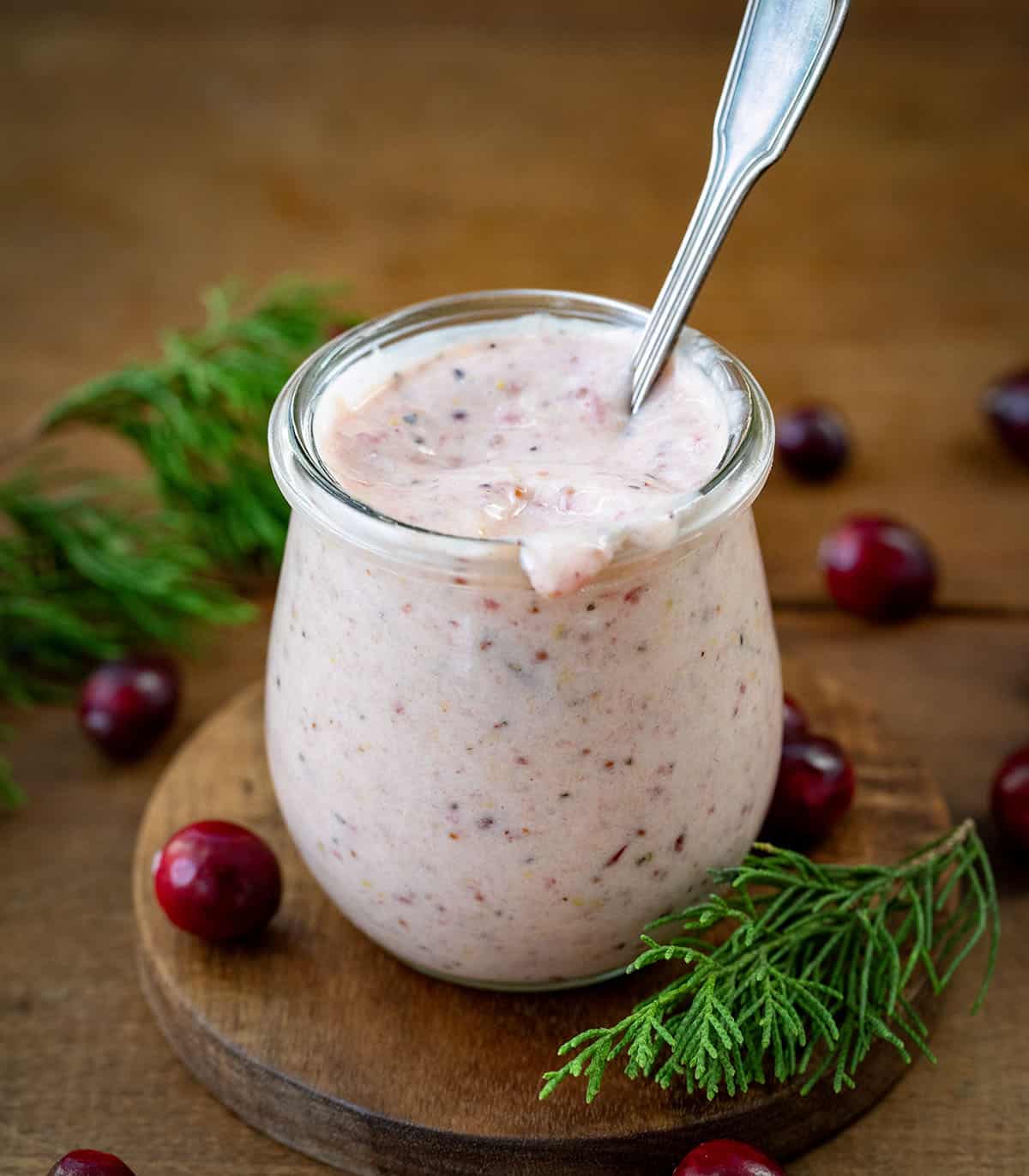 Jar of Cranberry Aioli with a spoon in it.