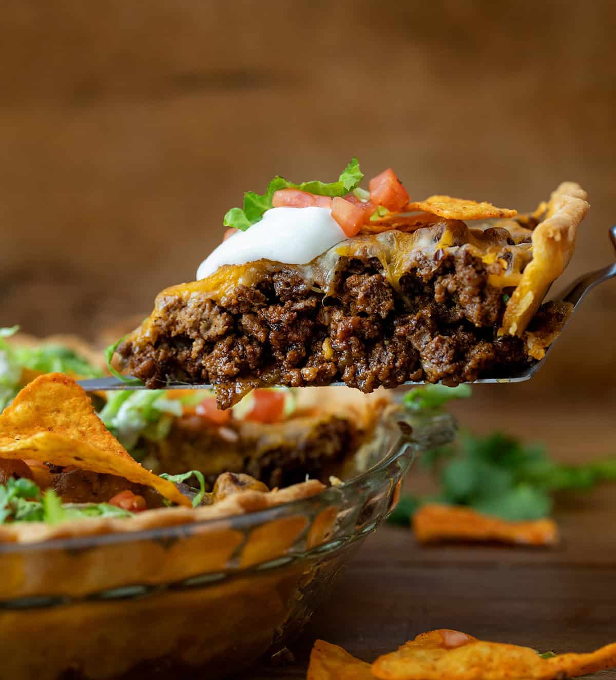 Piece of Dorito Taco Pie on a spatula being lifted from pie pan.