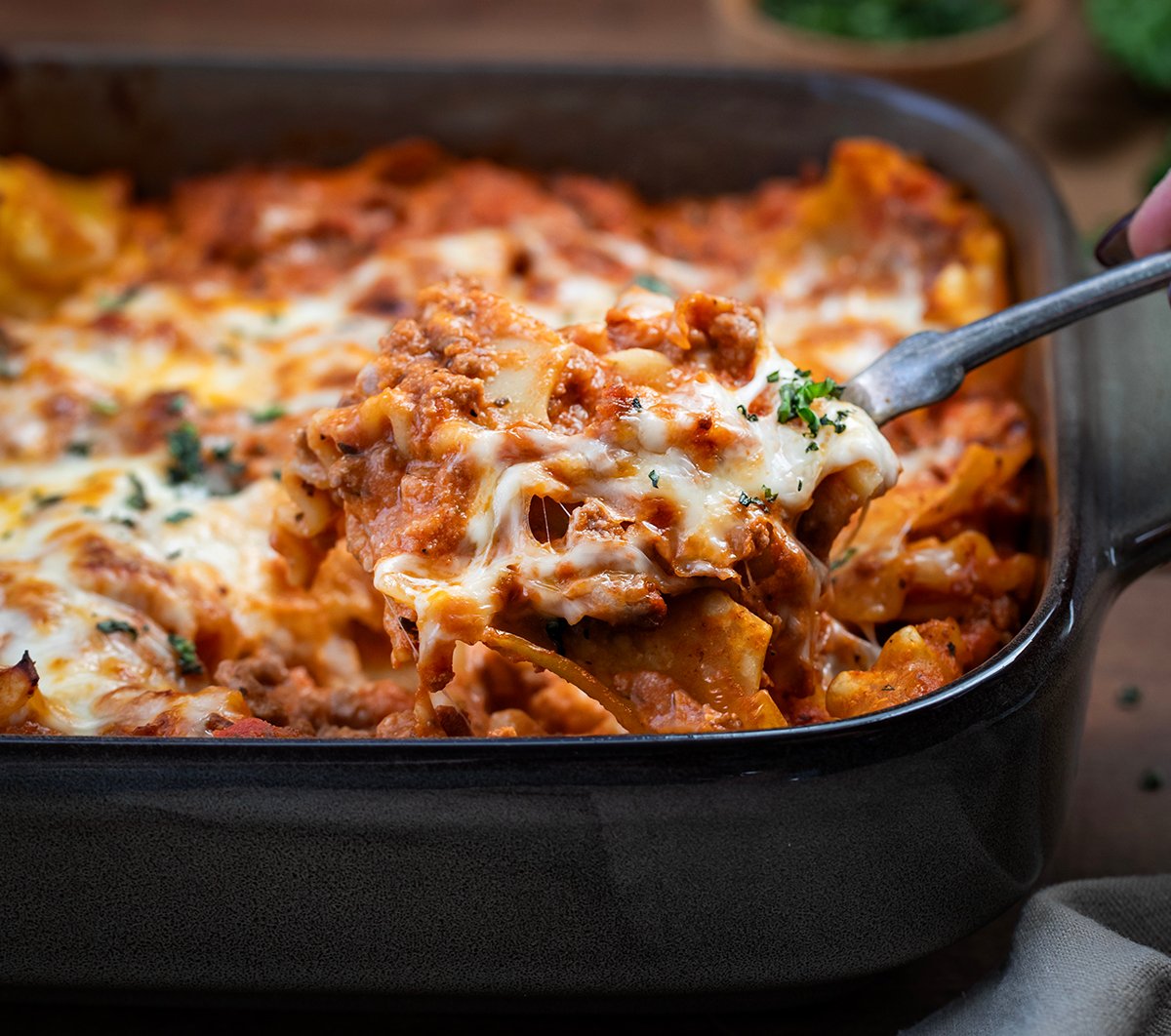 Scooping out a portion of Easy Lasagna Casserole from the pan.