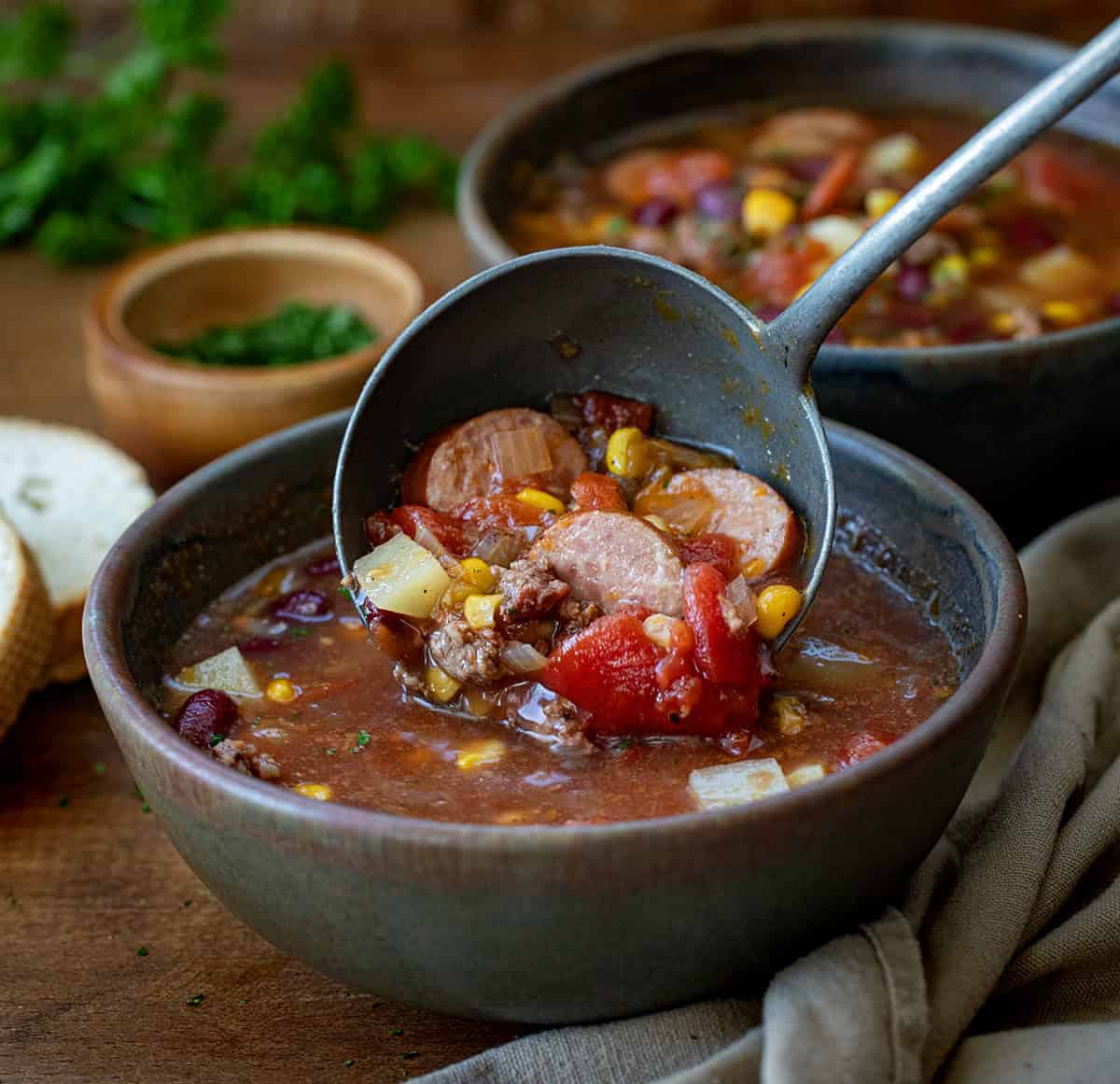 Using a ladle to put soup into a bowl.