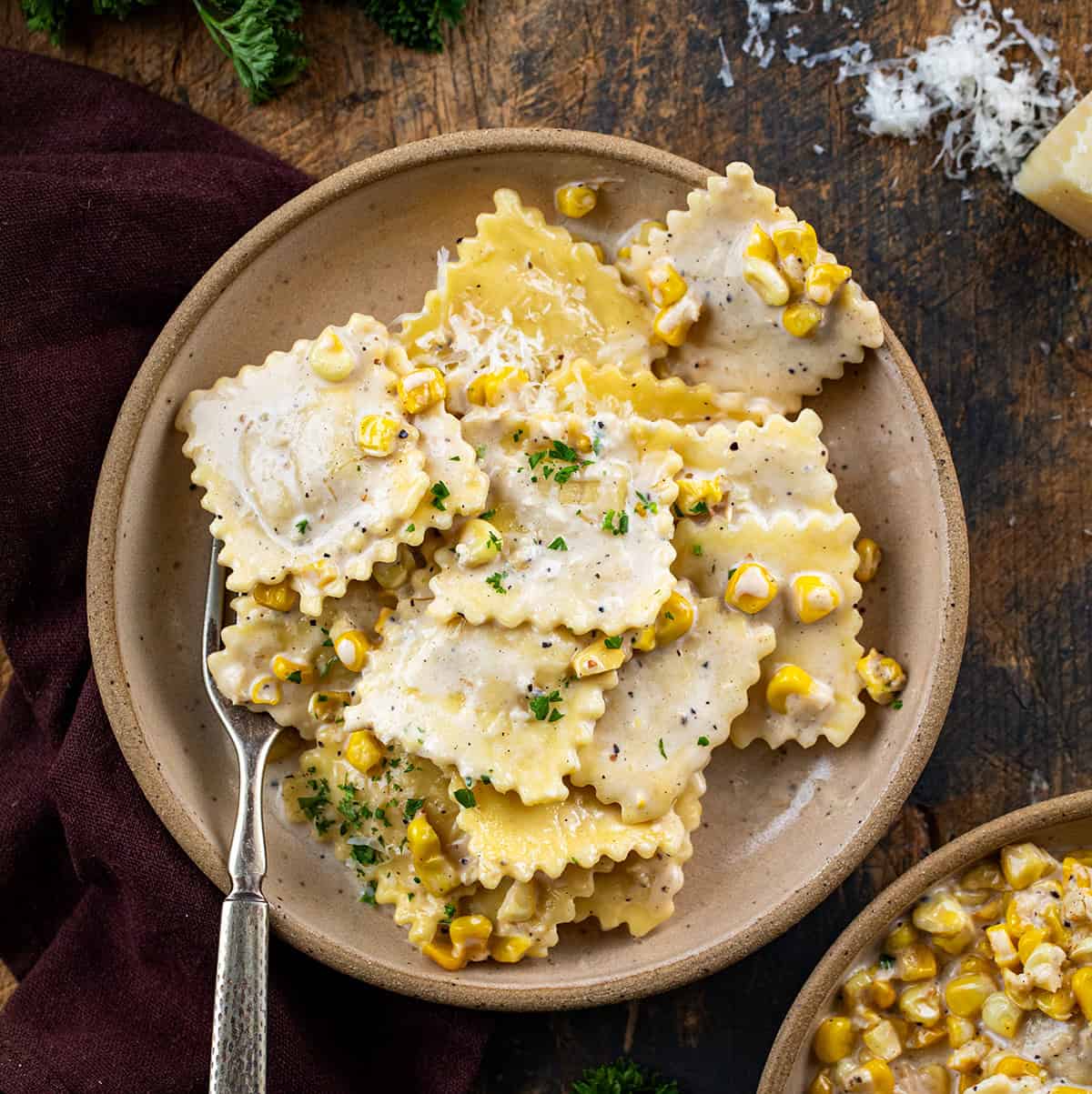 Plates of Sweet Corn Ravioli on a wooden table from overhead.