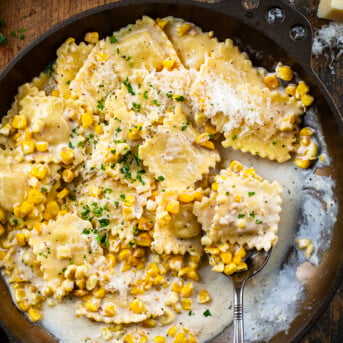 Sweet Corn Ravioli in a skillet with a spoon.