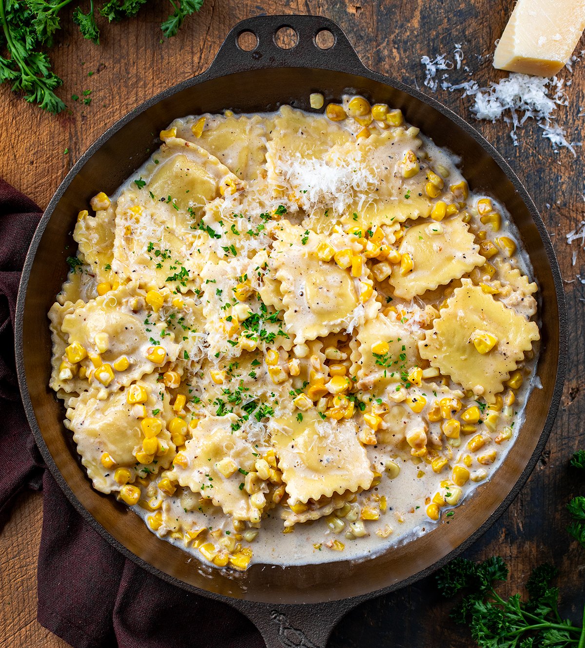 Sweet Corn Ravioli in a skillet on a wooden table from overhead.