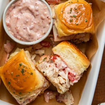 Turkey Melt Sliders in a pan with Cranberry Aioli.