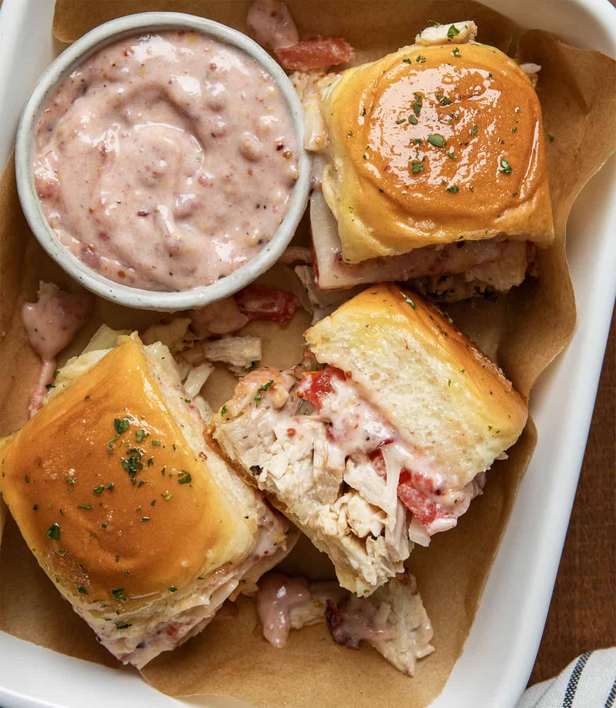 Turkey Melt Sliders in a pan with Cranberry Aioli.