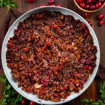 Skillet of Cranberry Bacon Jam on a wooden table from overhead.