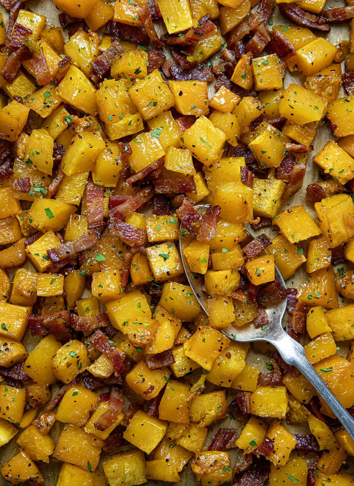 Close up of Maple Bacon Butternut Squash with spoon resting in it. 