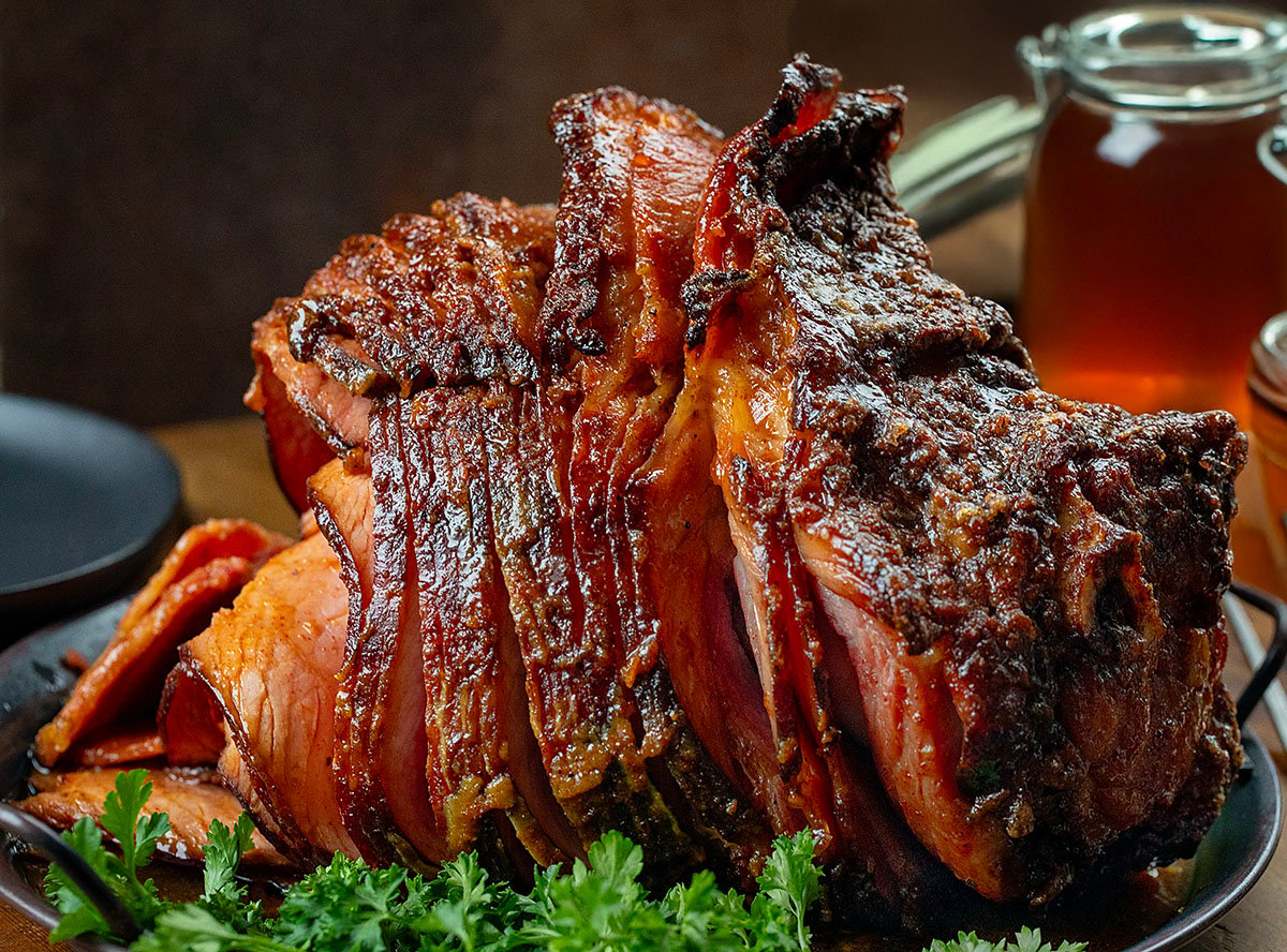 Spiraled Maple Bourbon Glazed Ham on a wooden table close up.