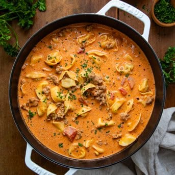 Pot of Sausage Tortellini Soup on a wooden table from overhead.