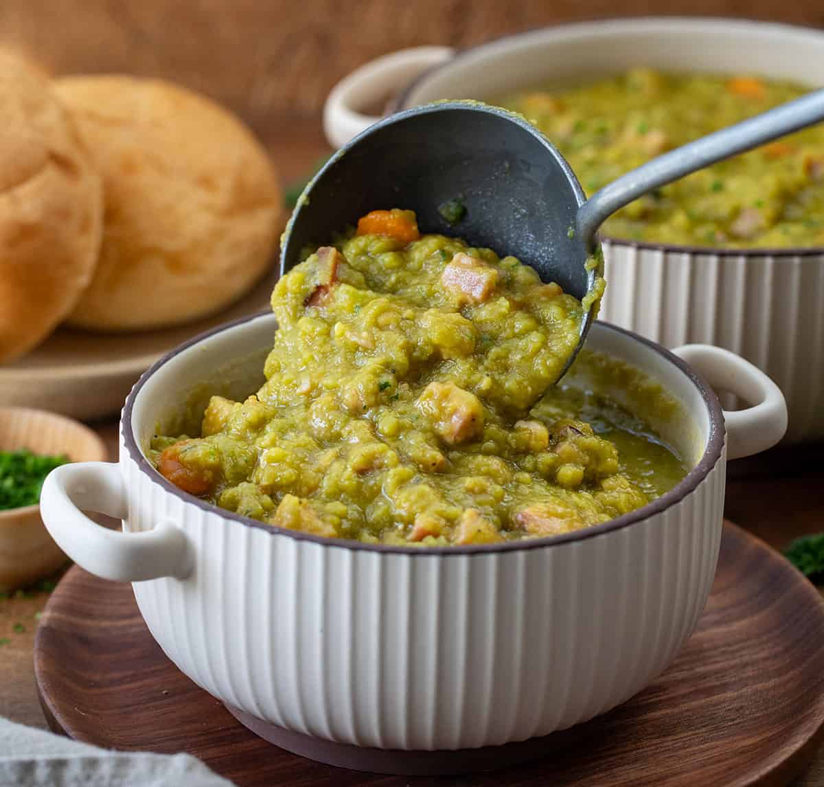 Using a ladle to put Split Pea and Ham Soup into a bowl.