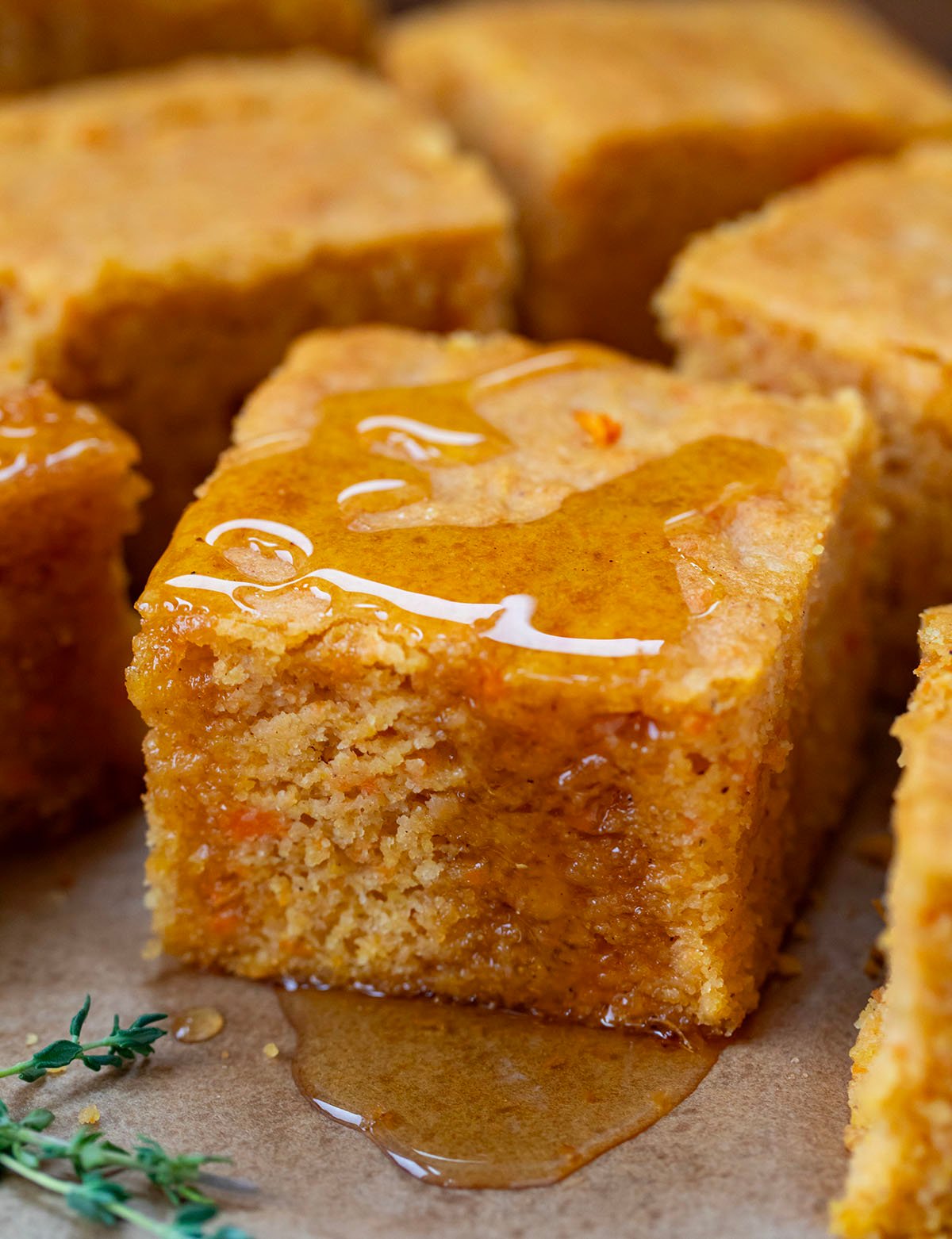 Piece of Sweet Potato Cornbread with honey on it close up.