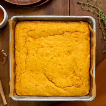 Pan of Sweet Potato Cornbread on a wooden table from overhead.