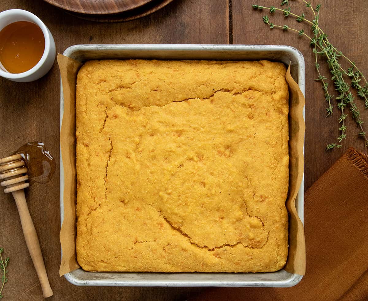 Pan of Sweet Potato Cornbread on a wooden table from overhead.