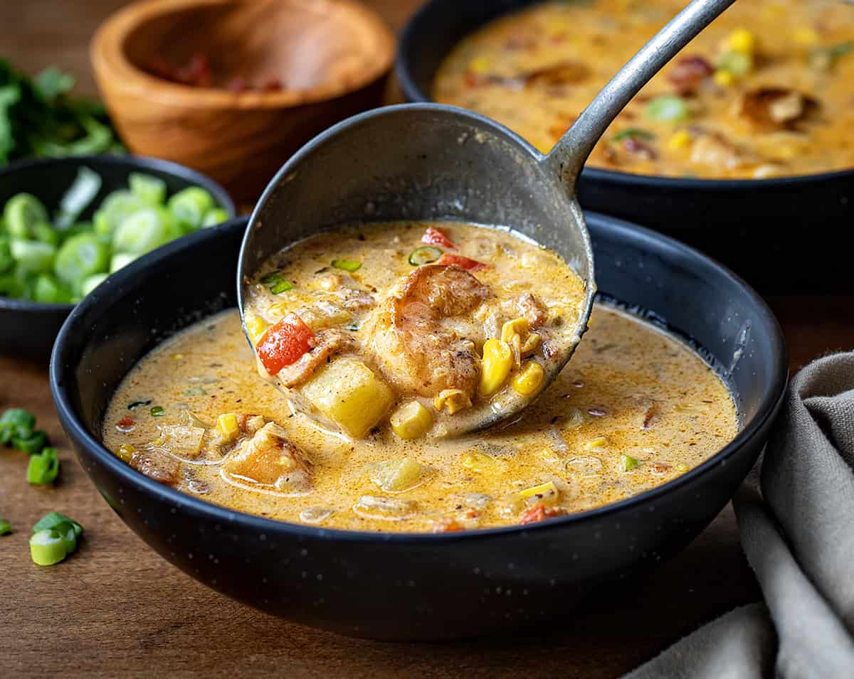 Putting Blackened Shrimp and Corn Chowder into a bowl.