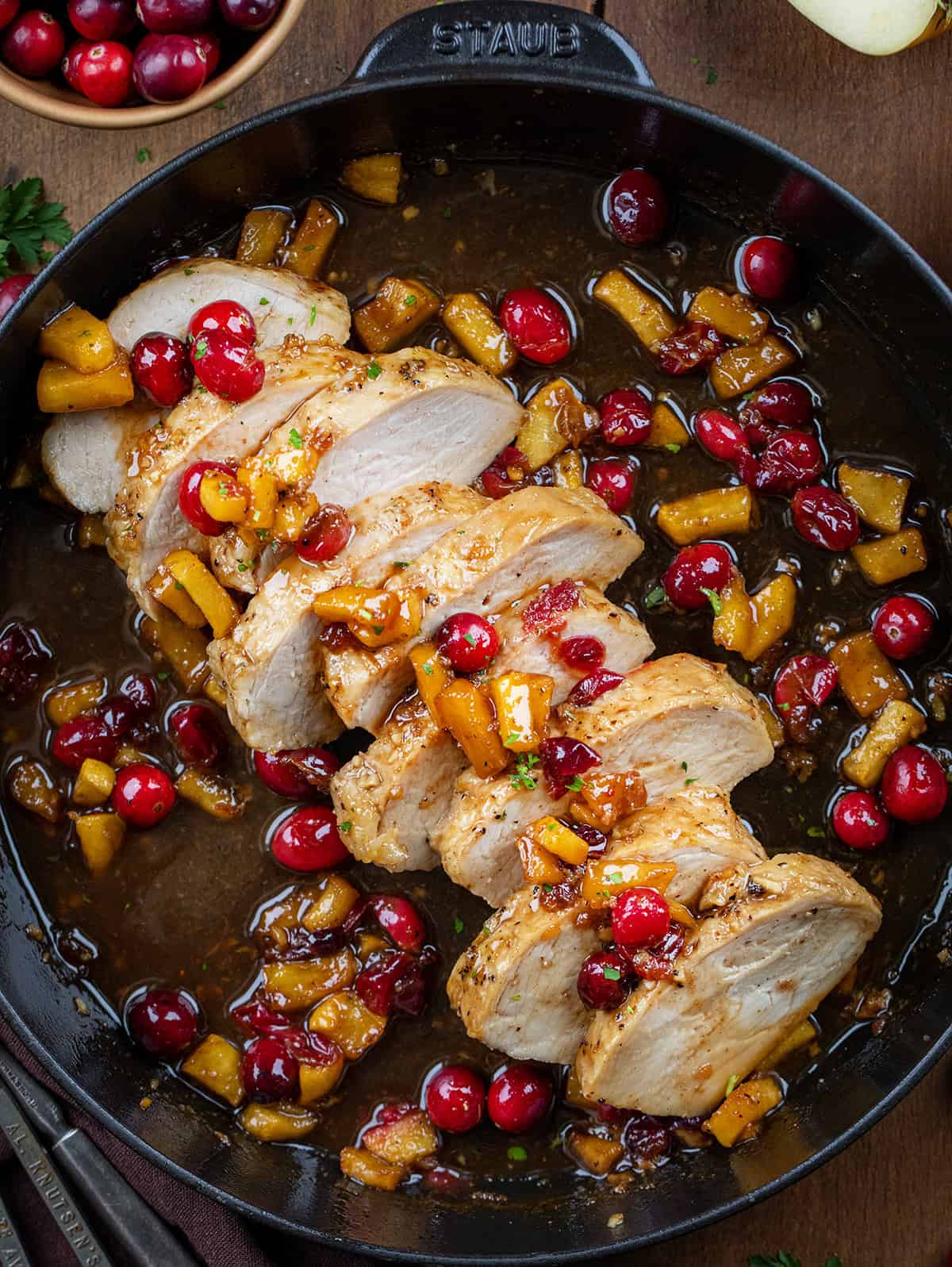 Sliced Cranberry Apple Pork Tenderloin in a black skillet from overhead.