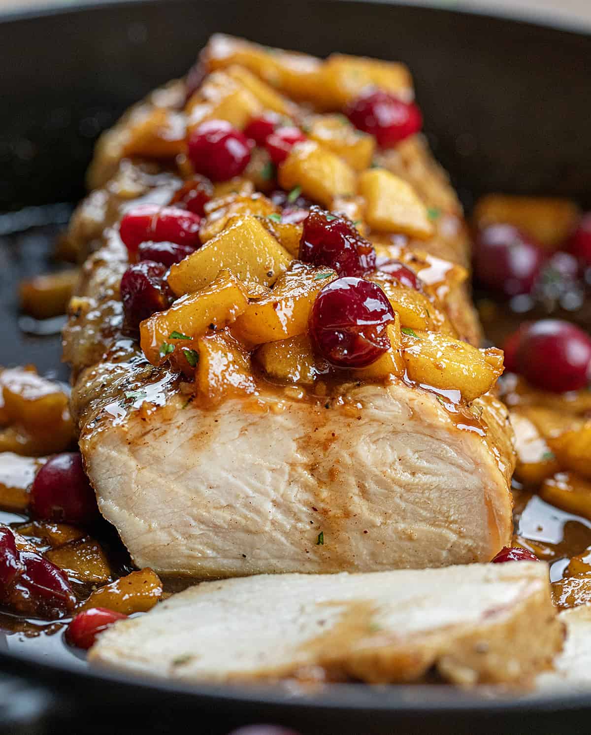 Freshly sliced Cranberry Apple Pork Tenderloin in a skillet.