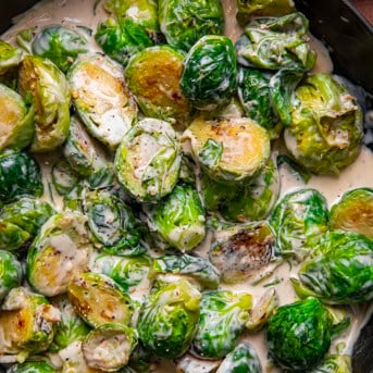 Creamy Garlic Parmesan Brussels Sprouts in a skillet from overhead.