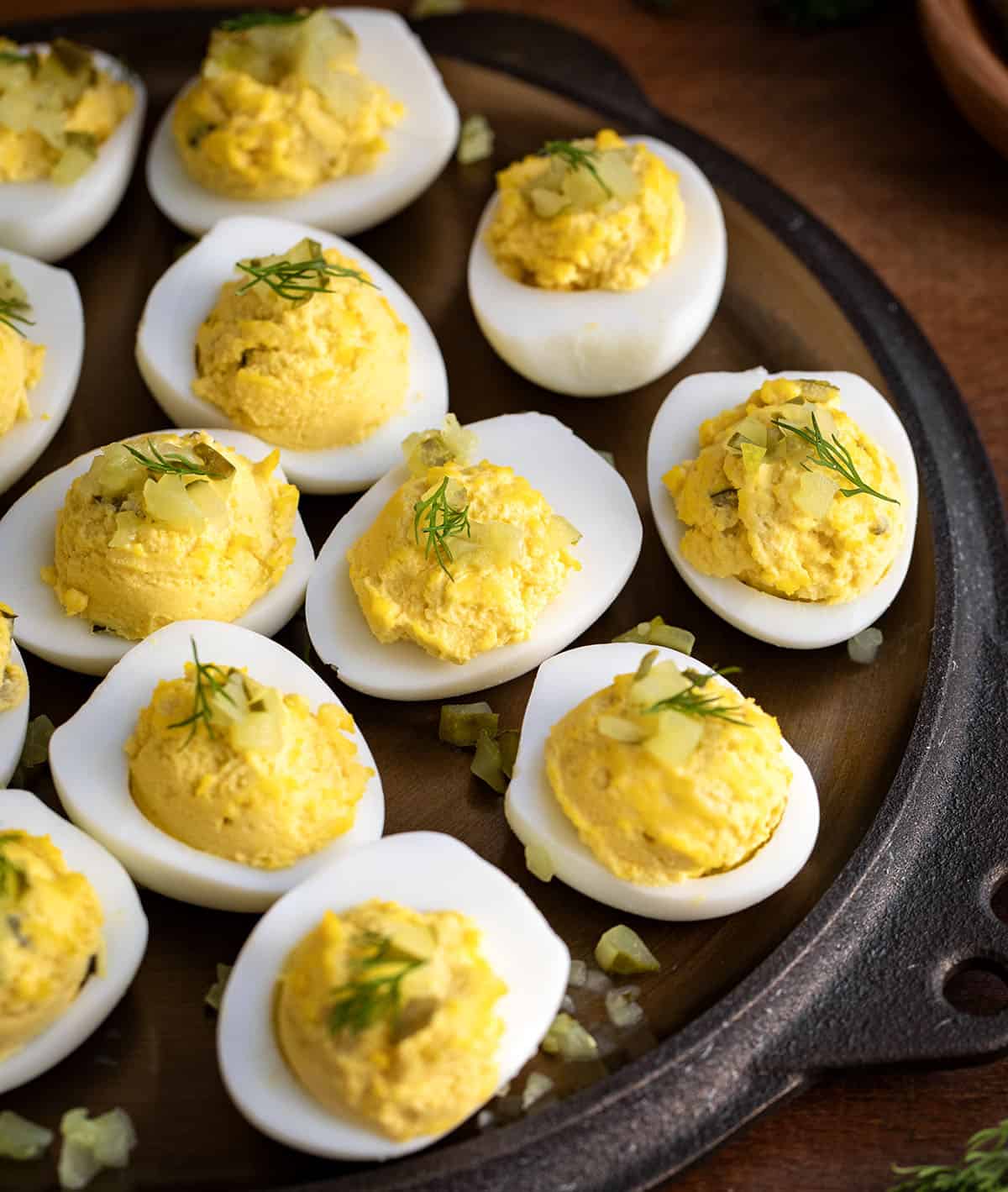 Close up of Dill Pickle Deviled Eggs on a skillet.