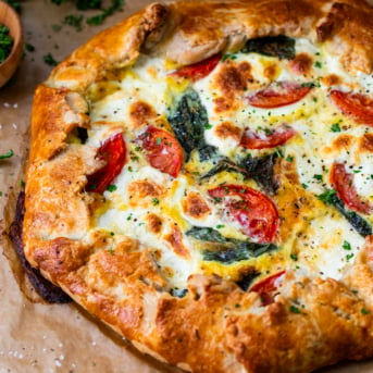 Close up of Caprese Galette on brown parchment paper.