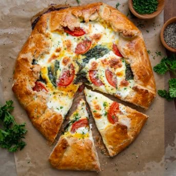 Cut into Caprese Galette from overhead.