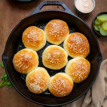 Skillet of Cheeseburger Bombs on a wooden table from overhead.