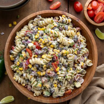 Bowl of Chipotle Lime Pasta Salad on a wooden table from overhead.