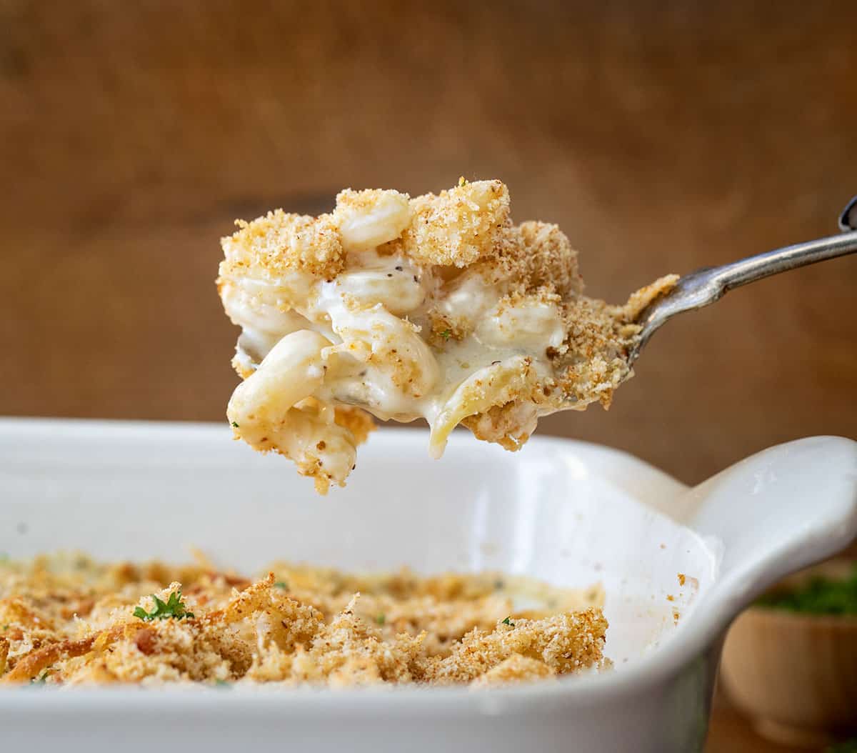 Spoonful of Garlic Parmesan Mac and Cheese being lifted up from the pan.