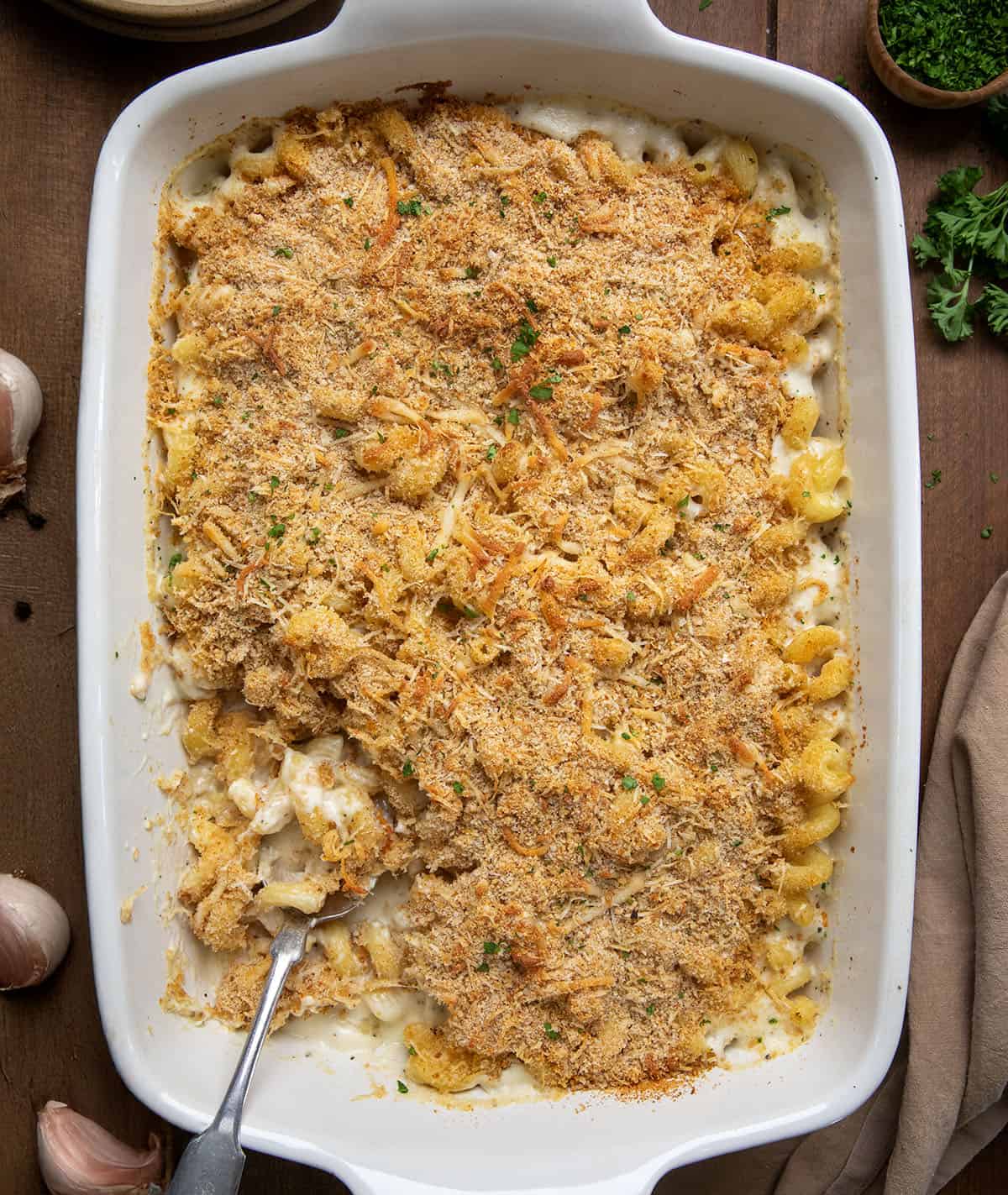 Pan of Garlic Parmesan Mac and Cheese with one bite missing and spoon resting in the pan. 